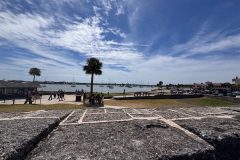 wall of Castillo de San Marcos National Monument and sailboats in the distance