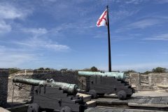 Closer look at the cannons and flag at Castillo de San Marcos National Monument